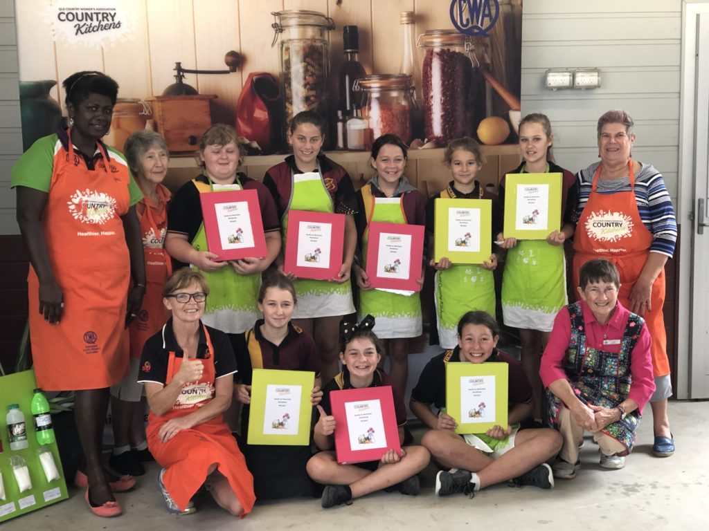Country Kitchens Central Regional Facilitator Rose Aston (left) with students at a Wallavile State School healthy cooking class.