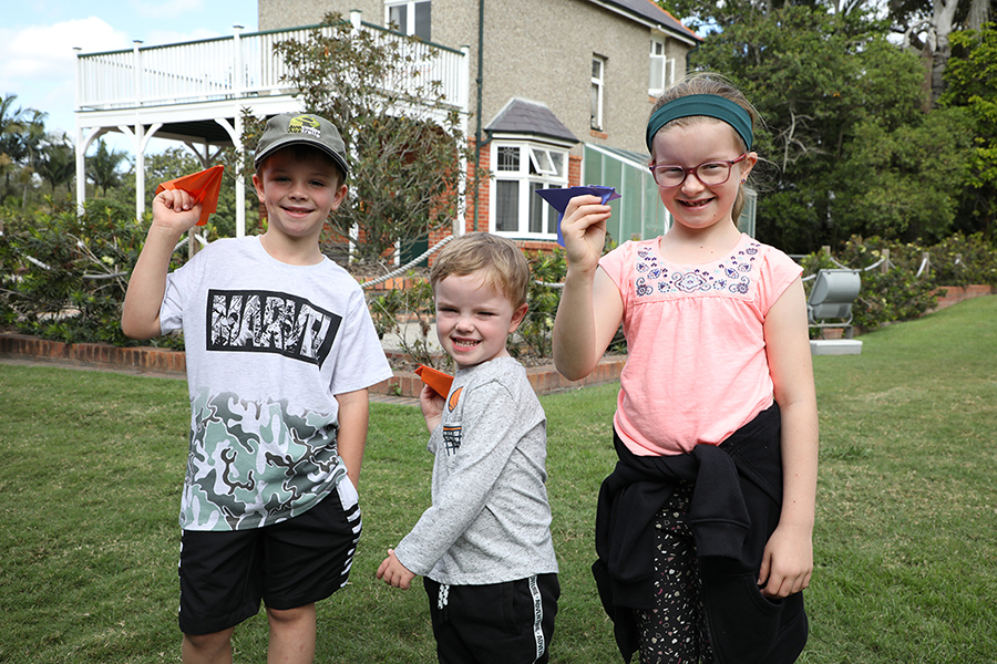 Luke, Riley and Holly Brown test out their paper planes at the Hinkler Hall of Aviation.
