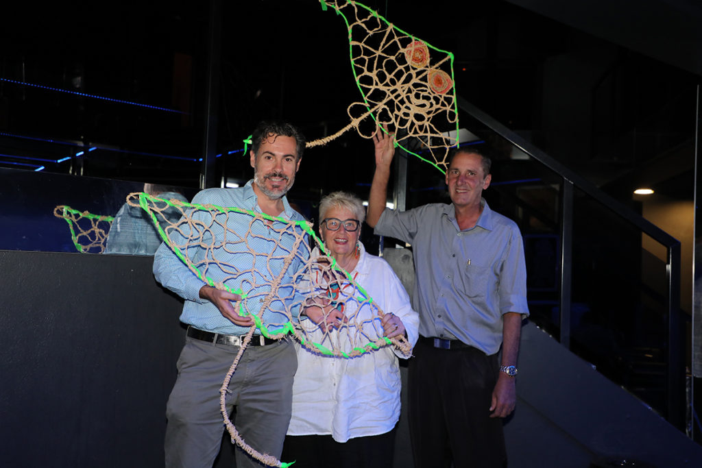 Creative Regions chair Michael Dart with artist Lyn Barton and Sugarland Tavern manager Jody Heiniger showing off the creations for the Cavern of Wonder. 