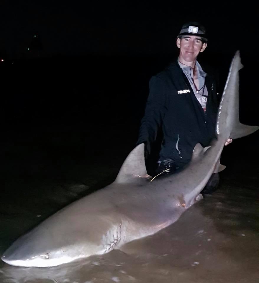 Jesse Spence with a 7ft 5 bull shark he caught in the Burnett River last week.