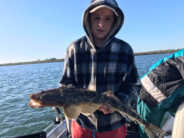 Logan Caville with the flathead he caught using a Zman soft plastic at the Kolan River during the school holidays.