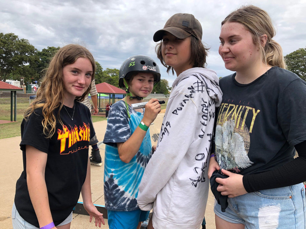 Autographing Ashlan Cutting’s hoodie at the Childers Skatepark are (from left) Jazmyn West, Cody Nibbs and Alyssa Priestley.