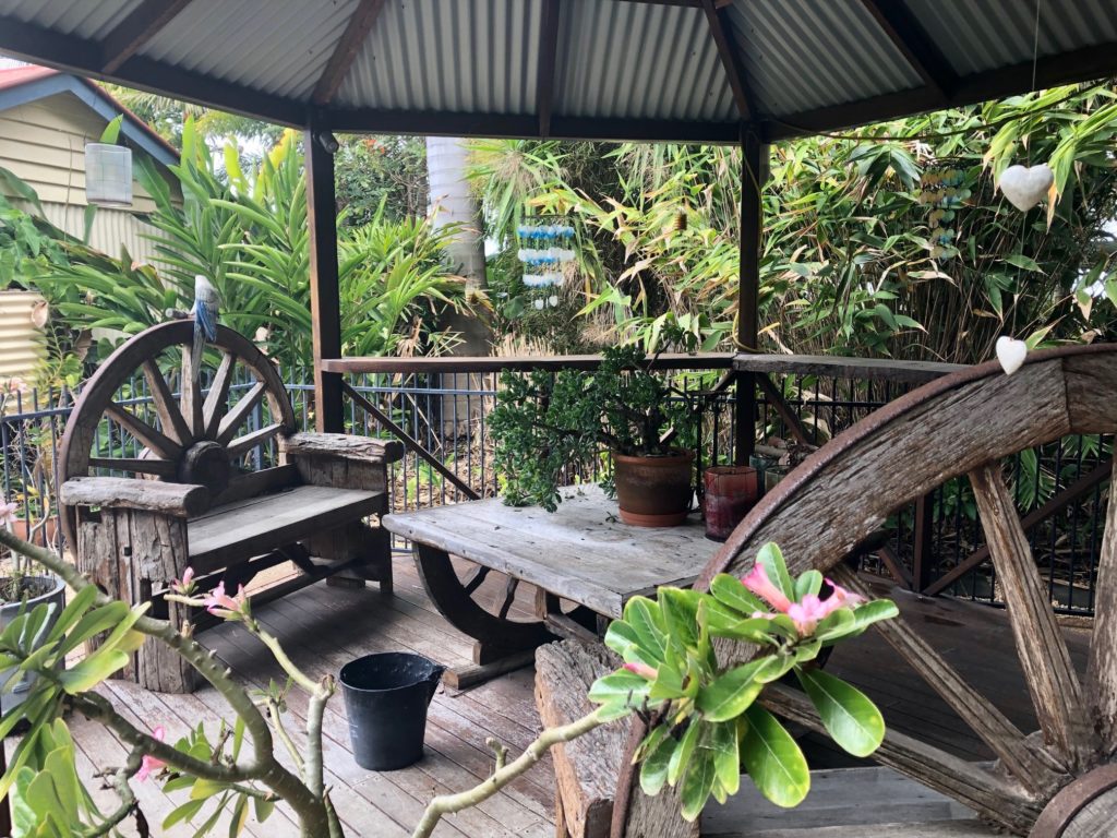 The rustic look achieved in the poolside pergola sets the tone for the adjacent gardens.