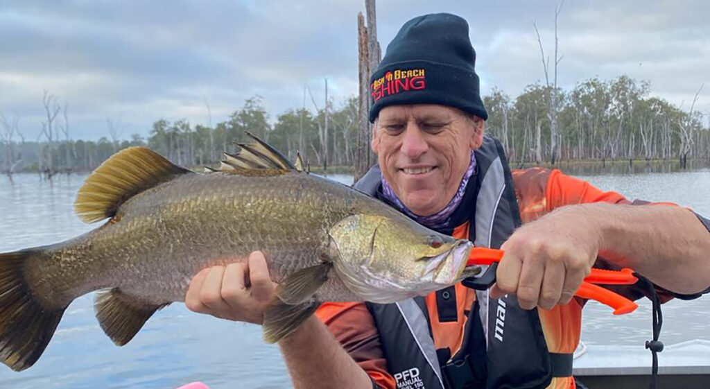Shane Hall with his first ever barra! This fish was caught at Lake Monduran on a Samaki Redic hardbody lure.