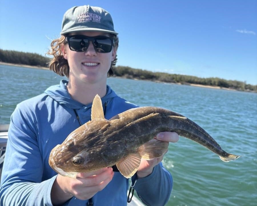 Team member Corey with a perfect eating sized flathead caught in Baffle Creek