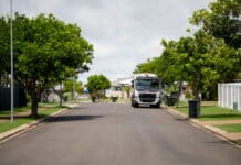 Garbage truck collecting waste and recycling bins.