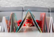 A boy dressed up with some books