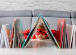 A boy dressed up with some books