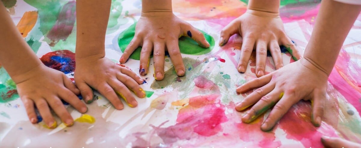 Children's hands in colourful paint
