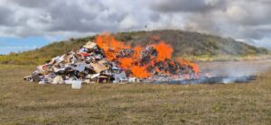 Battery sparks fire in a truck and the rubbish is seen burning in an open paddock.