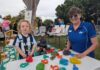 70 years of family fun at Childers U8’s Day Kobe Raynor enjoys the Childers Library station with Kim Greene.